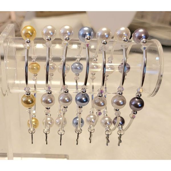 “Color variations of the Joyful Blessings Bracelet including white, teal, lavender, and yellow pearls”