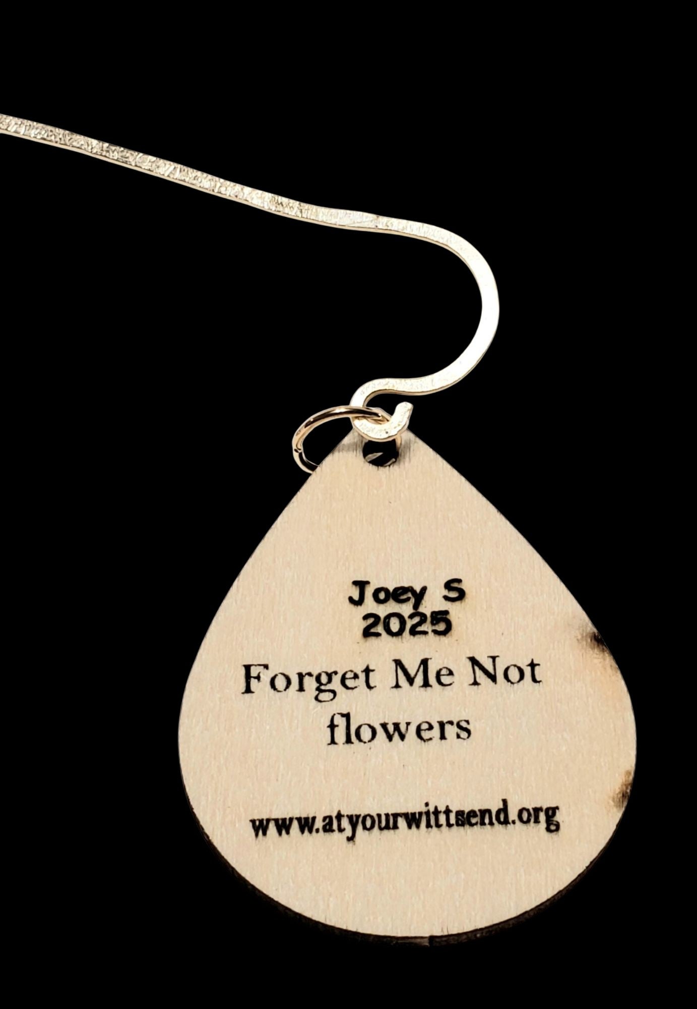 Customize the back of charm with your child's name. The "forget me not flowers" comes on the back. 