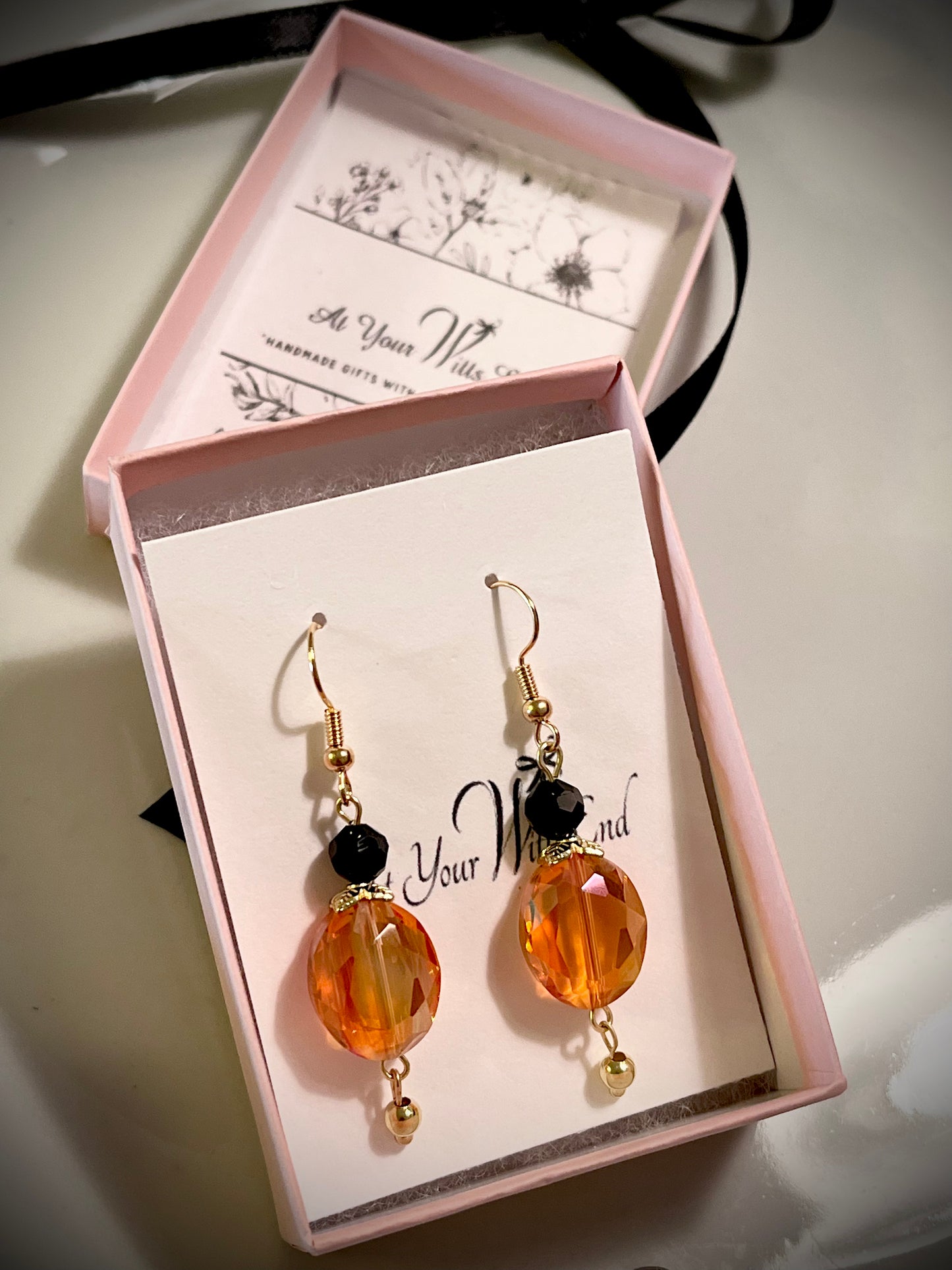 Orange crystal earrings with black